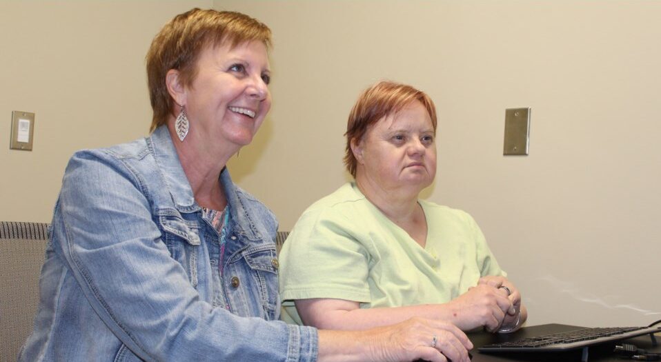 Community Living Guelph-Wellington executive director Cindy Kinnon and Fiona test out one of the new digital hubs.
