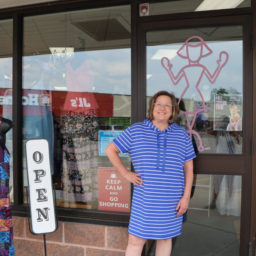 Holly is standing in front of her clothing boutique